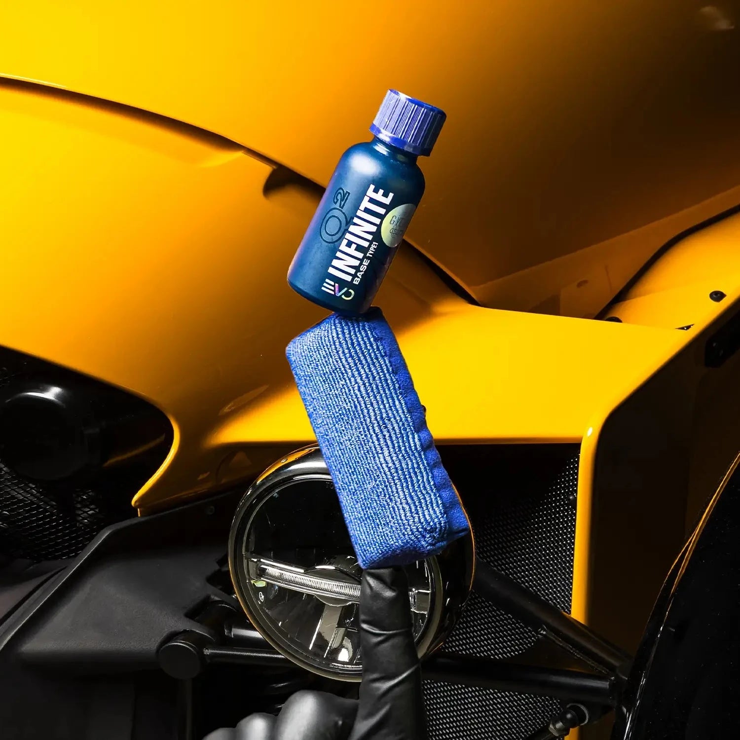 Atlanta Marietta Blue bottle labeled 'Q2 INFINITE EVO' on a yellow car hood