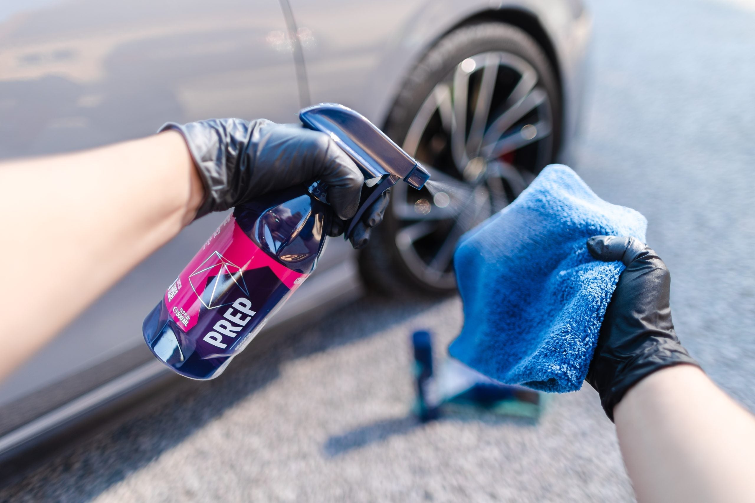 GYEON Prep being sprayed on microfiber with car in background in Marietta Atlanta Georgia